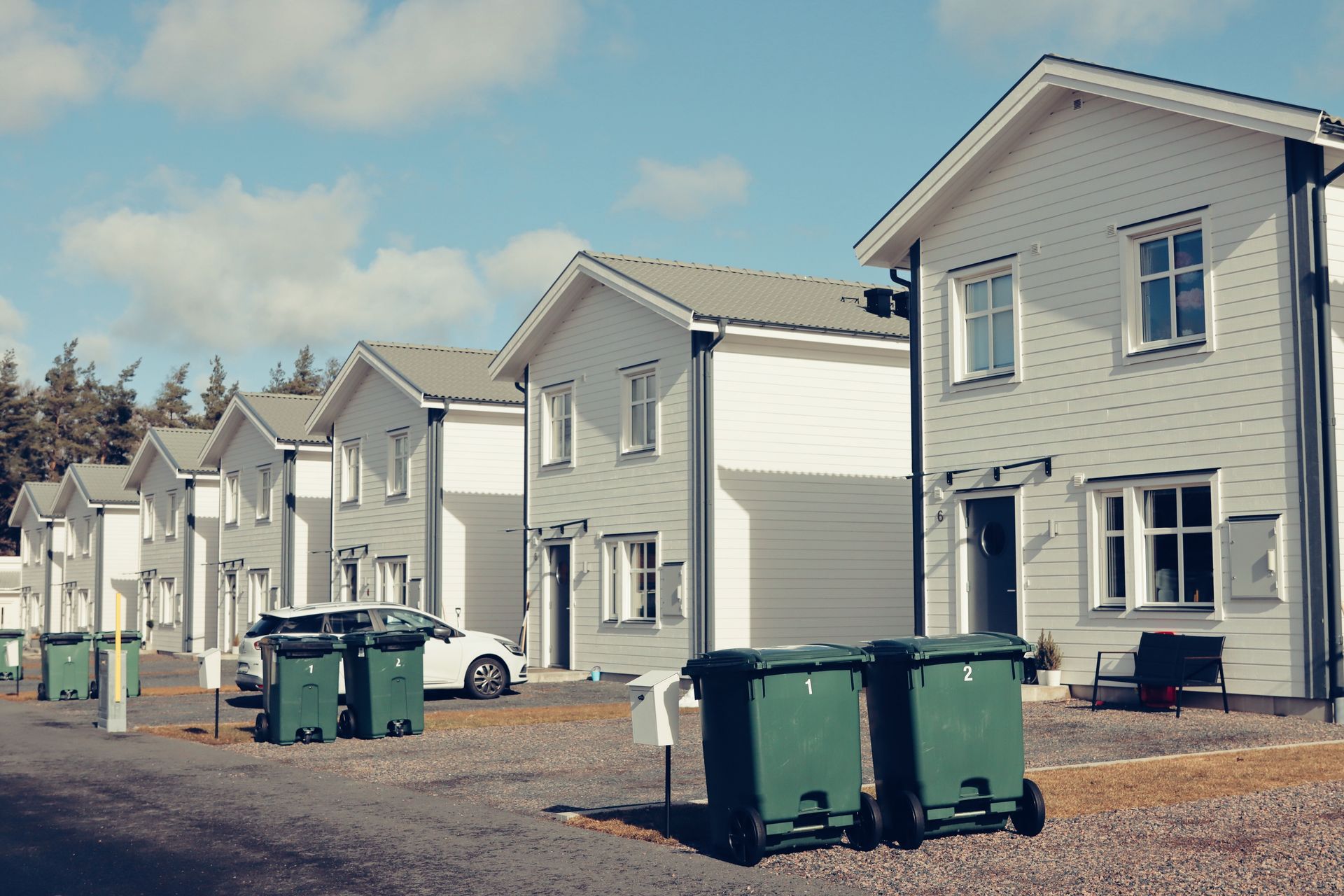 Street view of modern suburban houses in Jönköping, Sweden with clear blue sky.